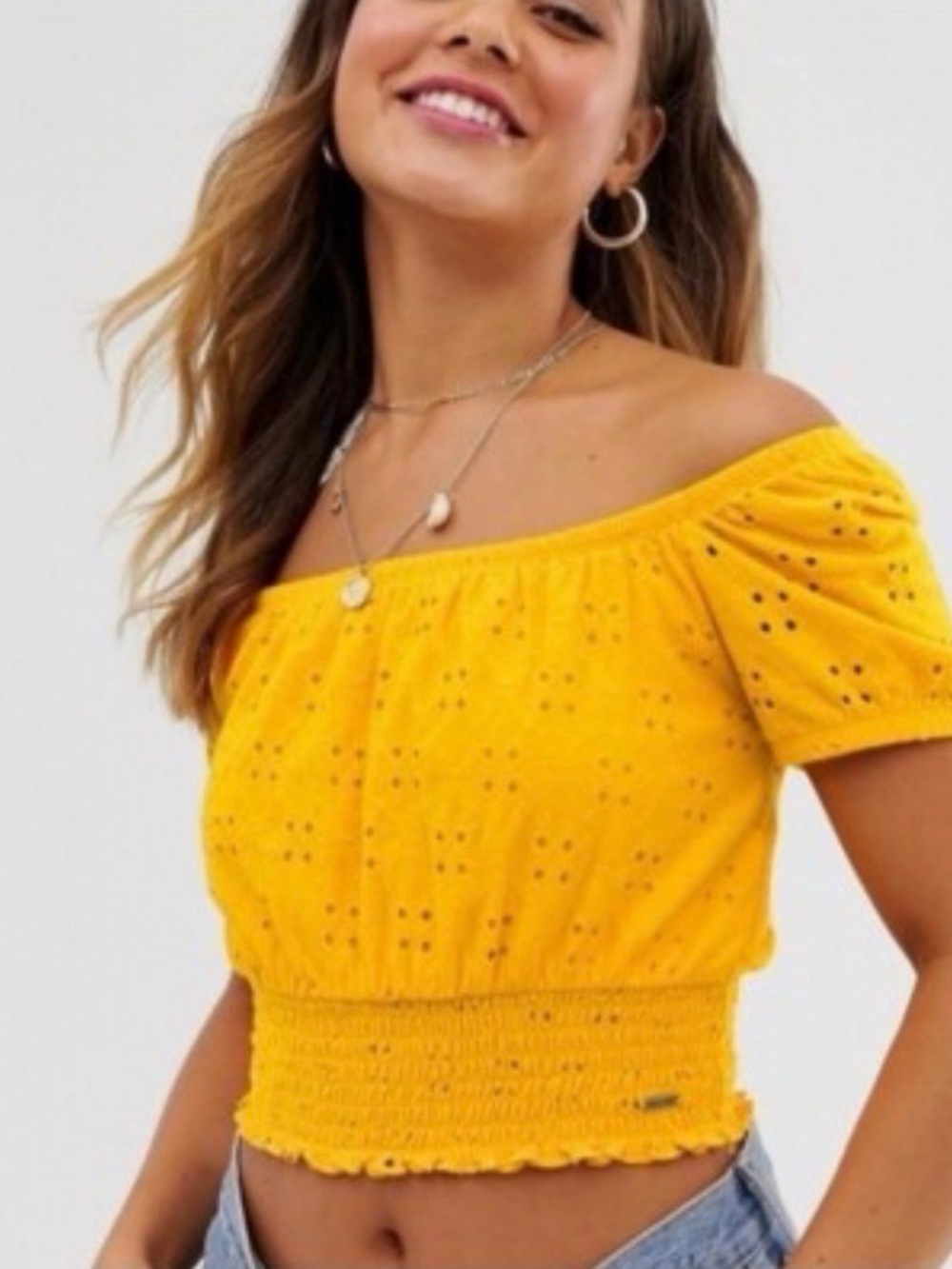yellow Hollister crop top featuring a smocked waist‎ and eyelet fabric.